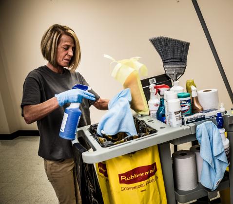 Person with cleaning cart